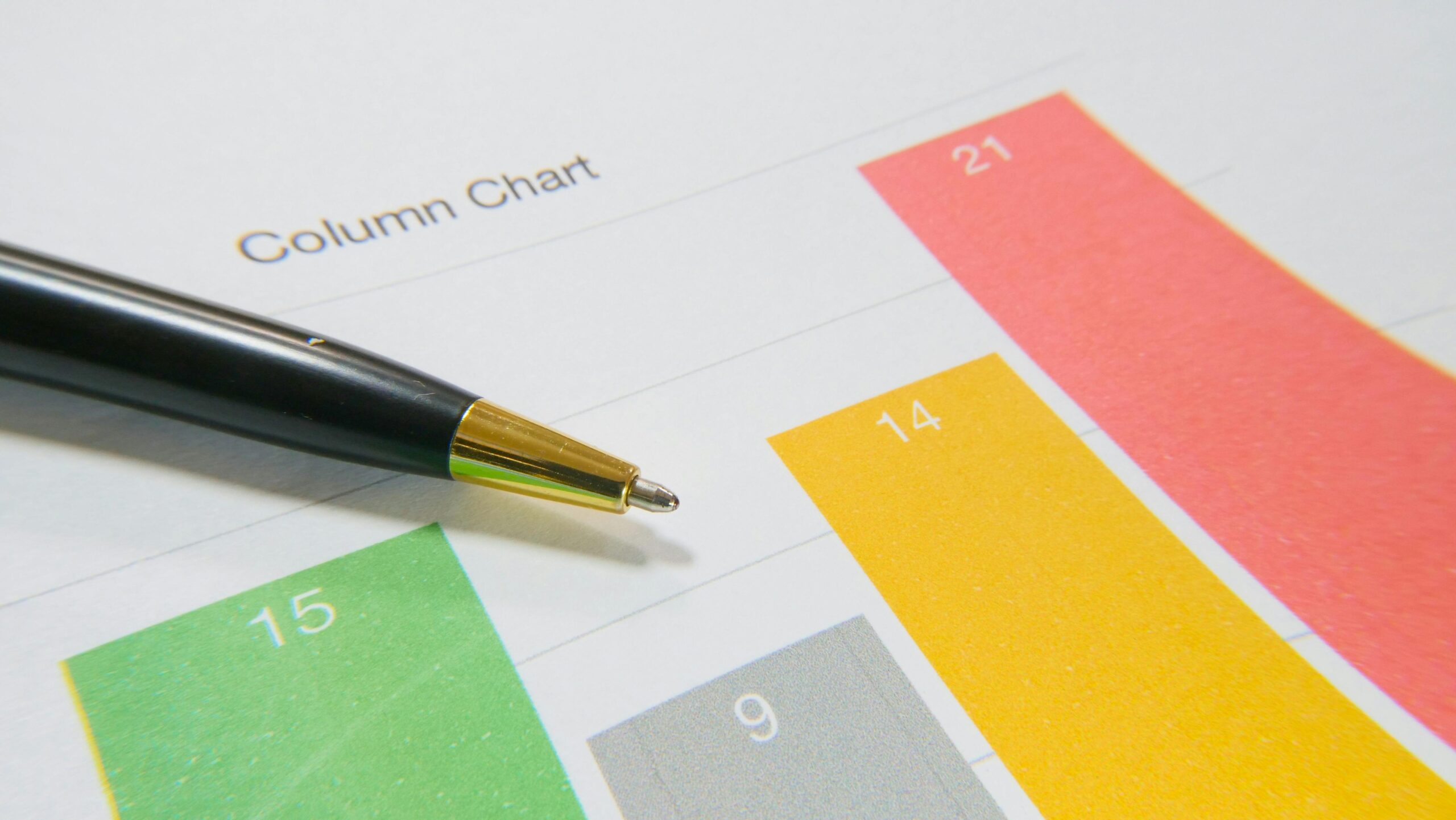A Pen Over A Paper With A Bar Chart Free Stock Photo
